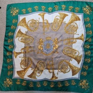vintage green scarf featuring bugles trumpets design with a coat of arms.